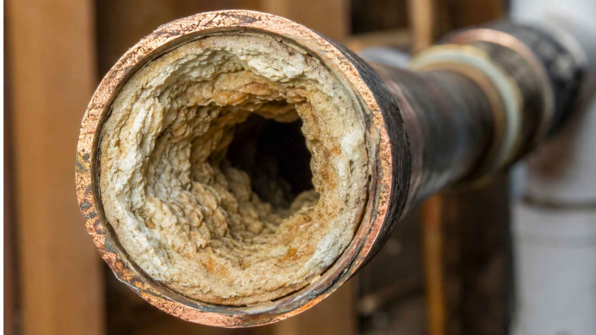 hard water plumbing mineral buildup inside residential pipe