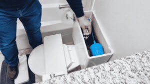 Open toilet tank showing internal components during a running toilet inspection.