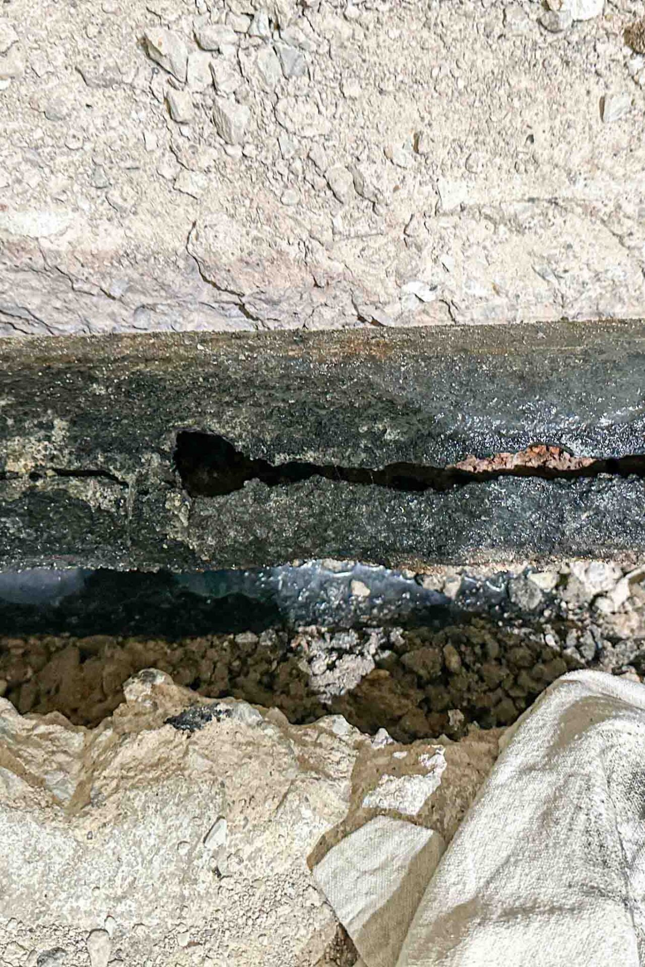 burst pipe repair technician examining frozen residential water line